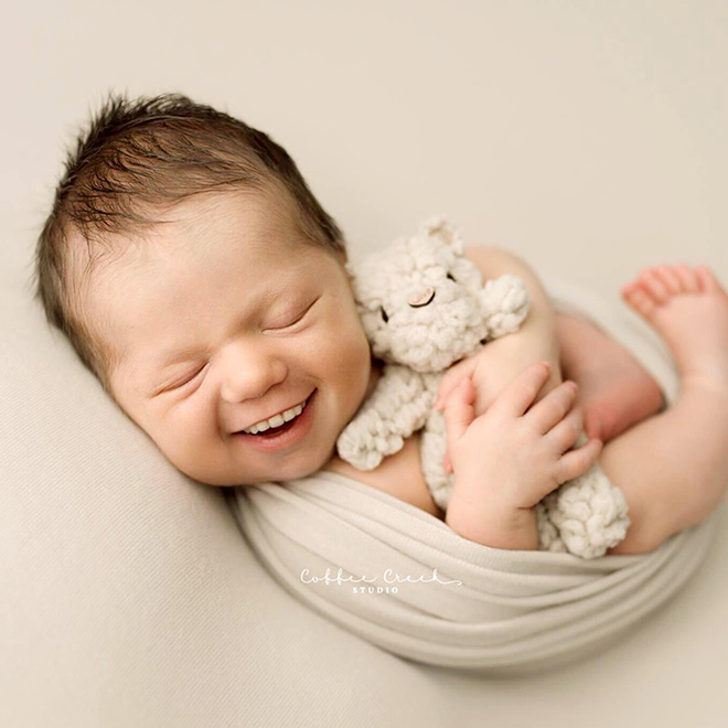 Baby with photoshopped smile.