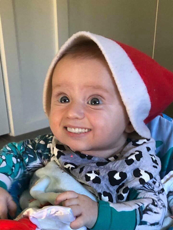 Baby with photoshopped smile.