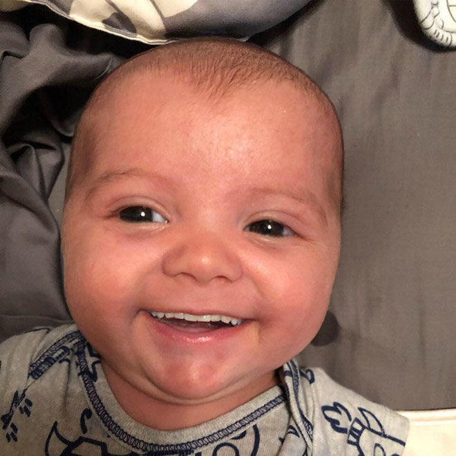 Baby with photoshopped smile.