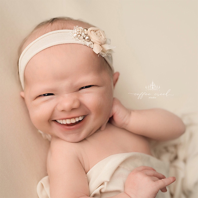 Baby with photoshopped smile.