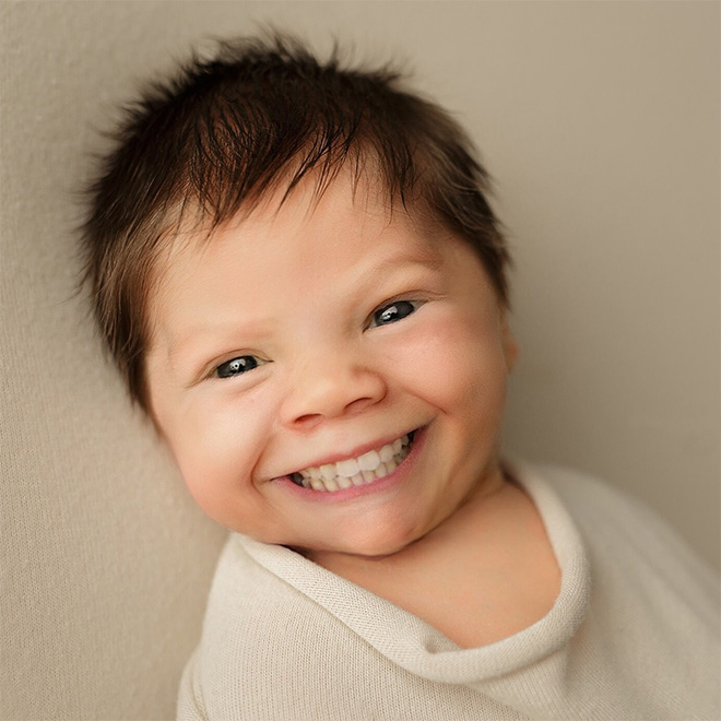 Baby with photoshopped smile.