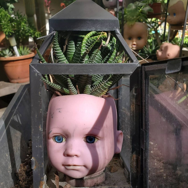 Creepy baby doll head planter.
