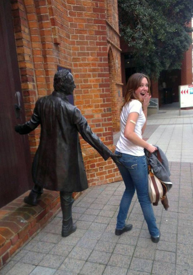 Having fun with statues.