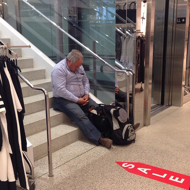 Miserable man trapped in shopping hell.