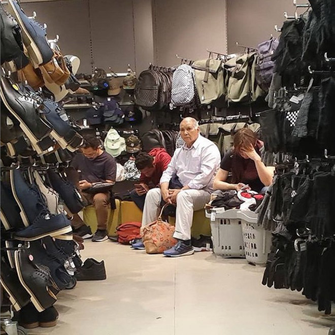 Miserable man trapped in shopping hell.